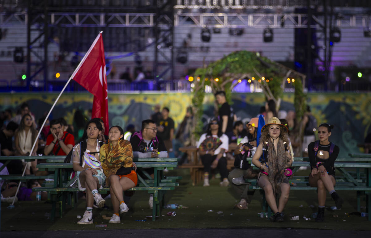 Festival attendees relax as the sun begins to rise during the second night of the Electric Dais ...