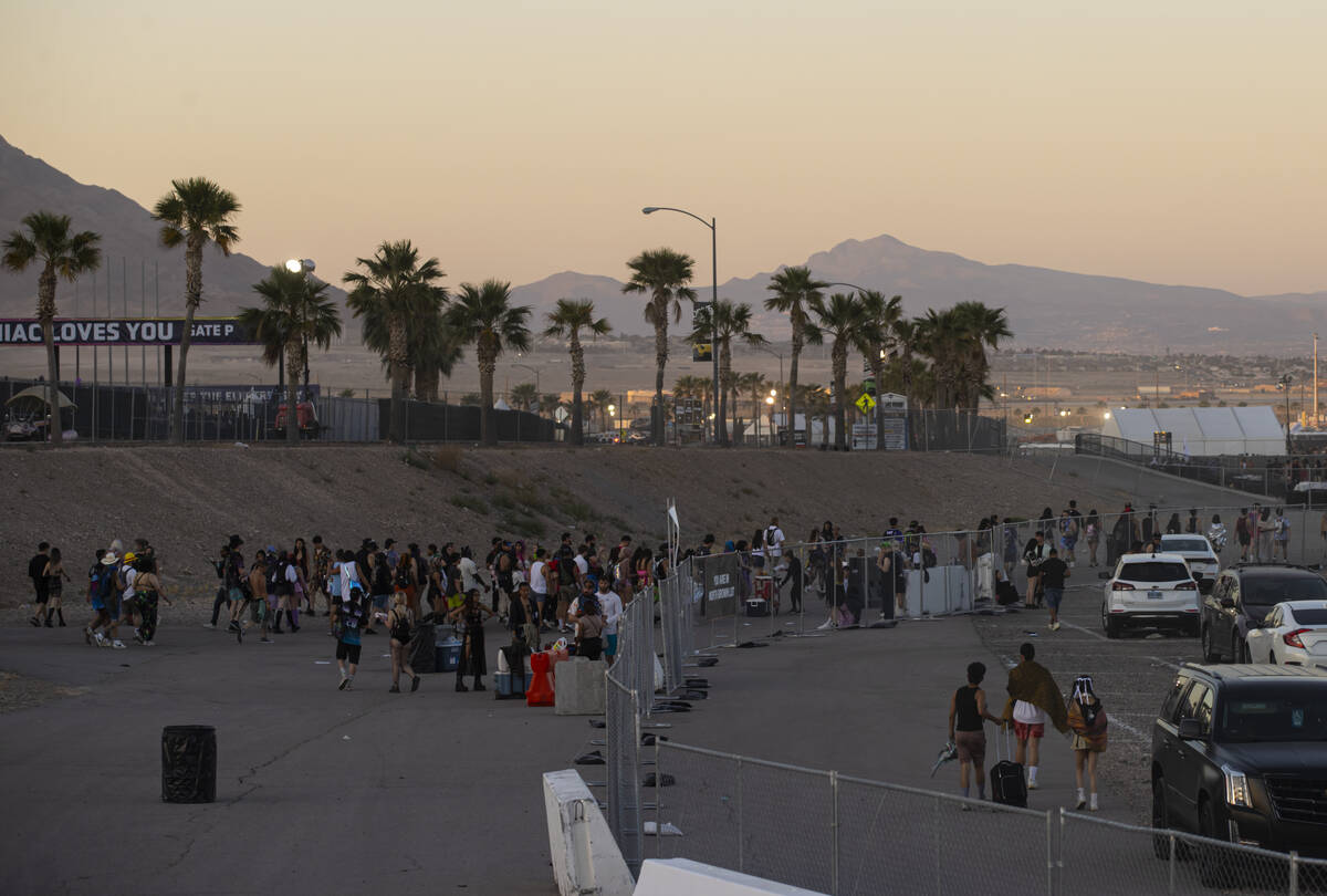Festival attendees walk to their cars at sunrise on the close of the second night of the Electr ...