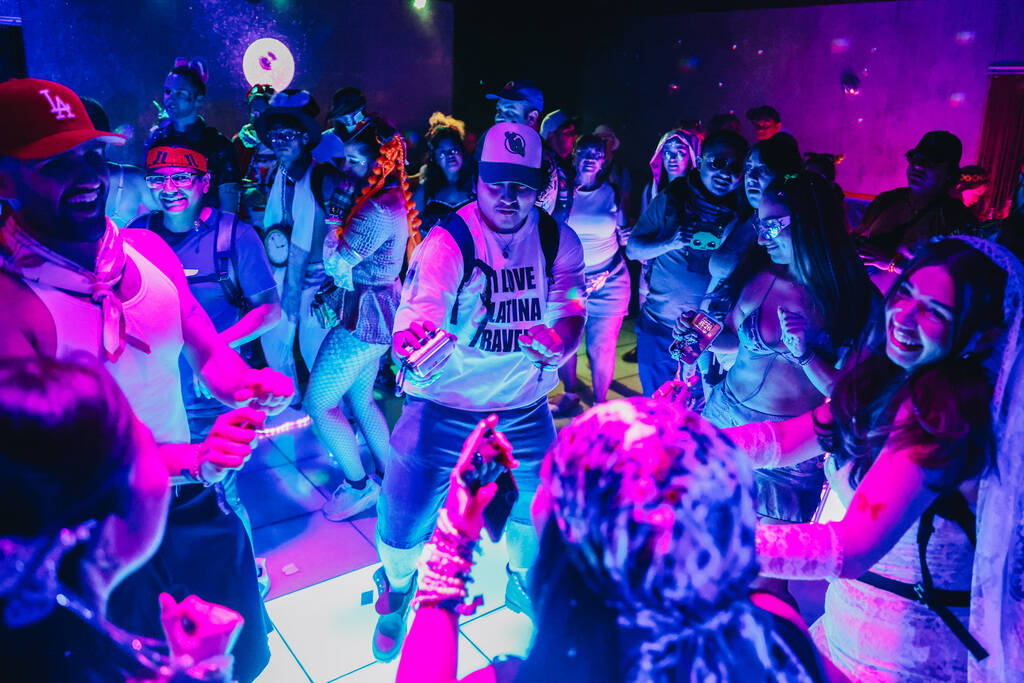 A group dances together during the second day of the Electric Daisy Carnival at the Las Vegas M ...