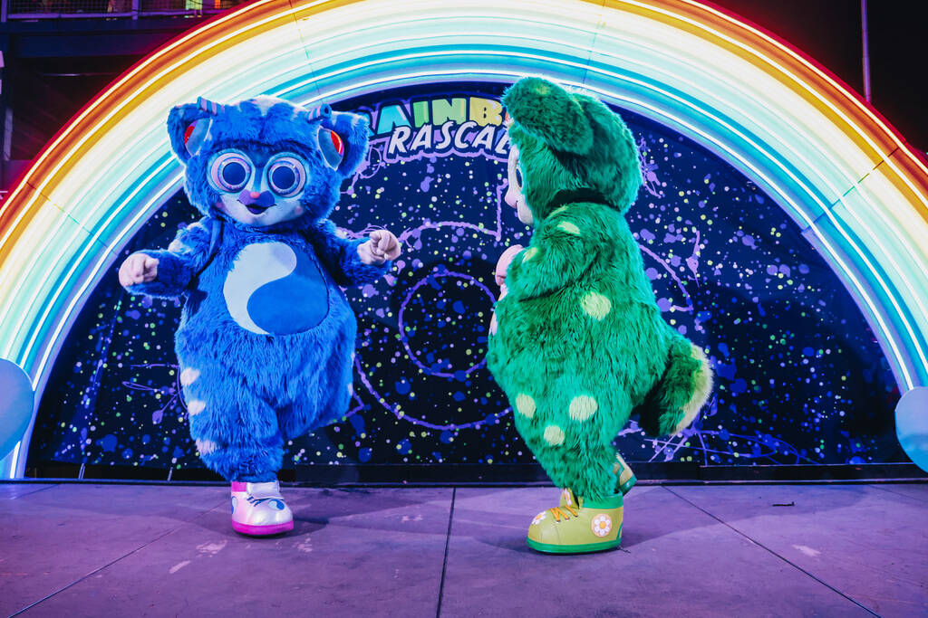 The Rainbow Rascals dance with each other during the second day of the Electric Daisy Carnival ...