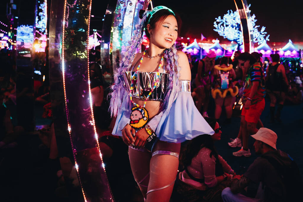 A festival attendee poses for photographs during the second day of the Electric Daisy Carnival ...