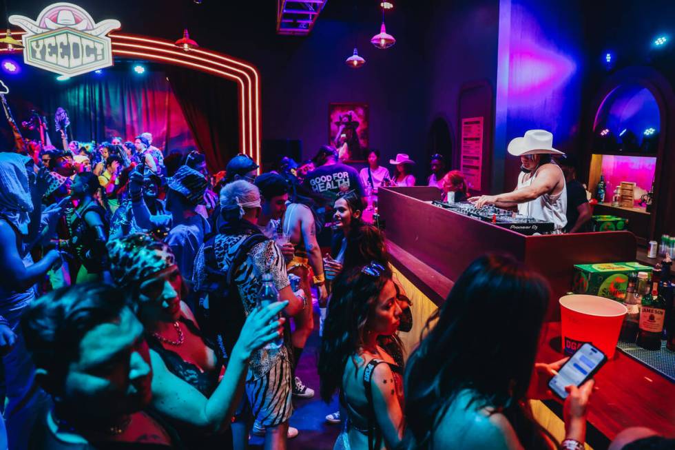 A DJ plays music inside of YeeDC on the third and final night of the Electric Daisy Carnival at ...