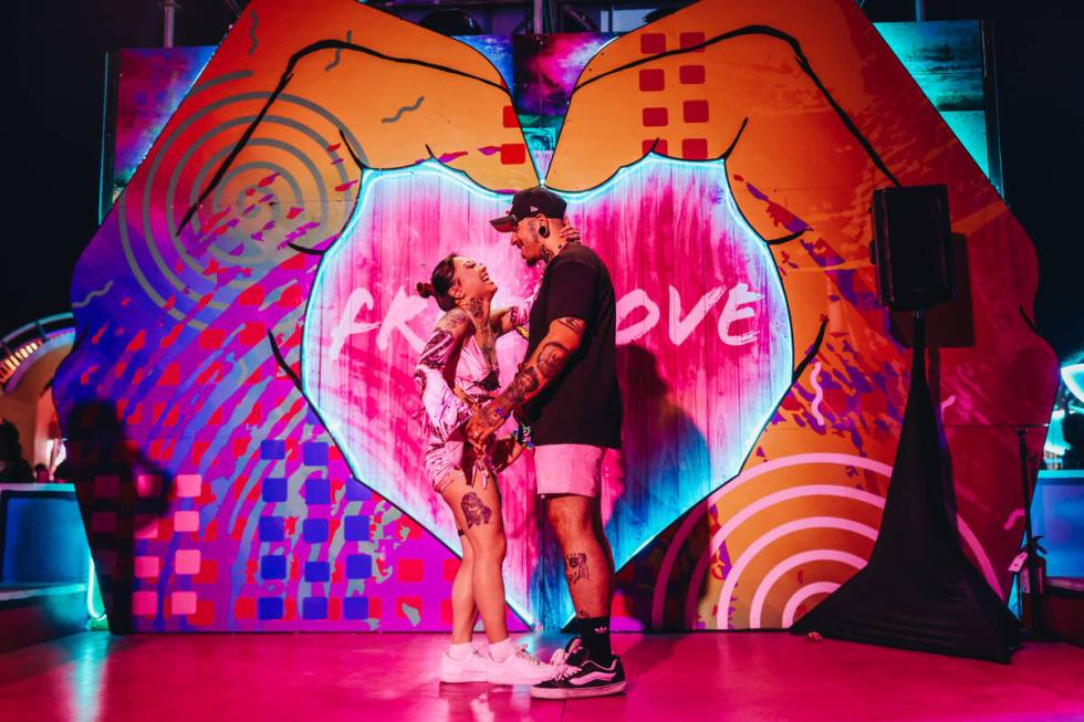 A couple embraces after finishing a fake wedding ceremony on the third and final night of the E ...