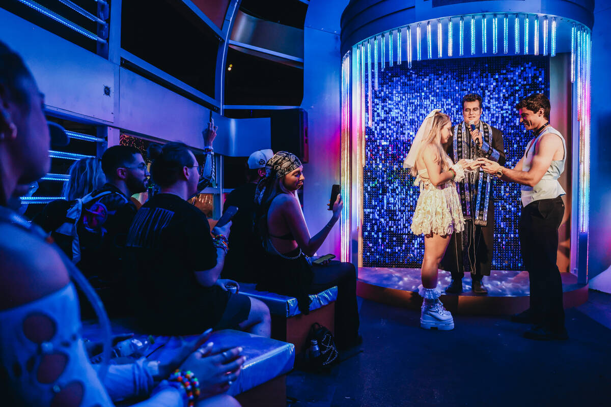 A couple exchanges rings as they get married on the third and final night of the Electric Daisy ...