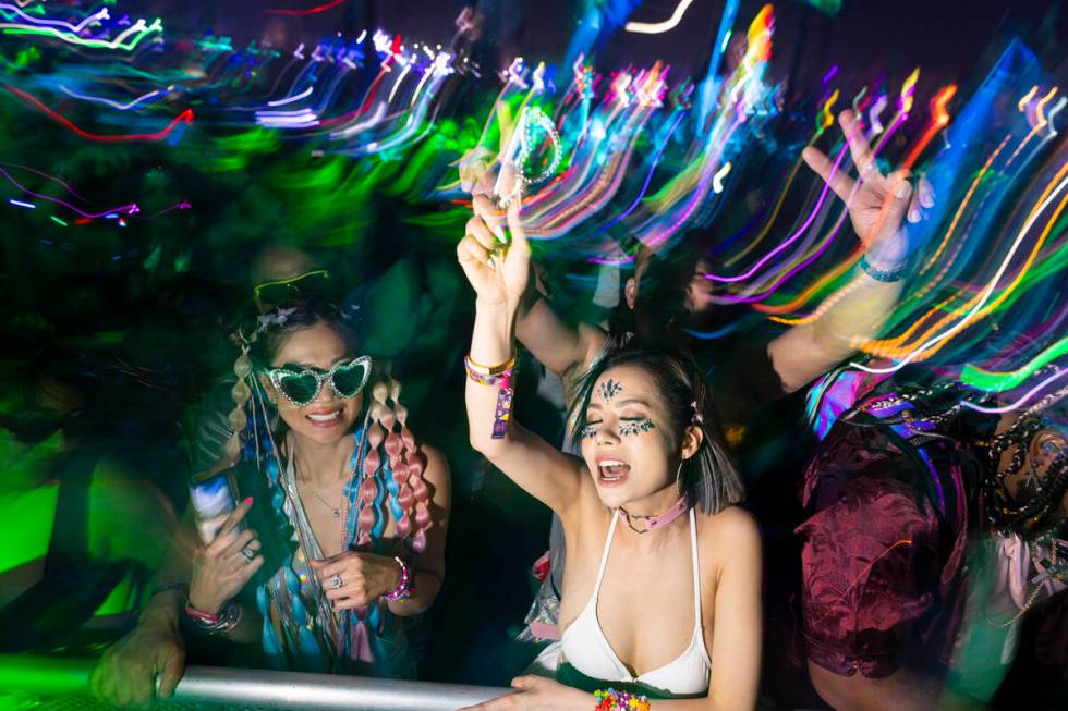 Festival attendees dance as Kaskade performs at Kinetic Field during the third night of the Ele ...