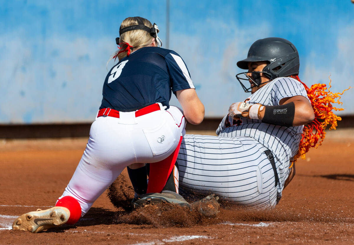 Douglas runner Lilyann Lee (44)attempts to slide into home plate covered by Coronado pitcher Ke ...