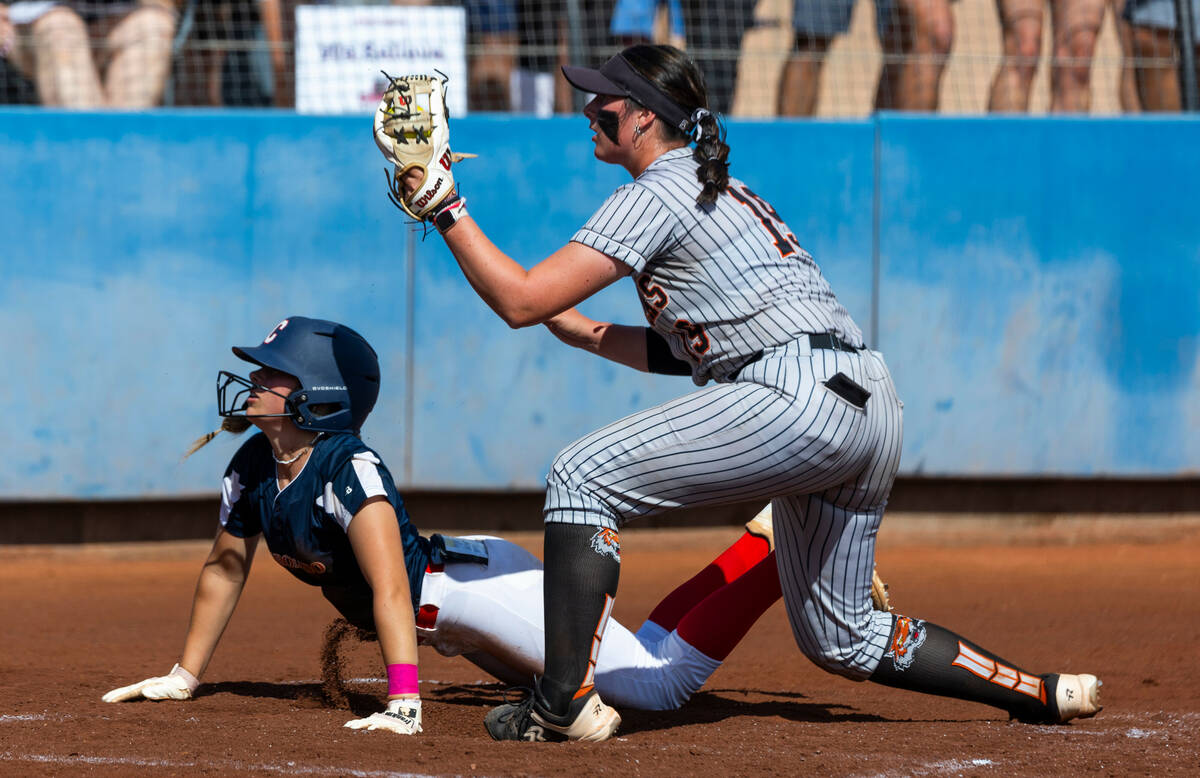 Coronado runner Charlotte Bendlin (21) looks to the umpire for the call after sliding into home ...