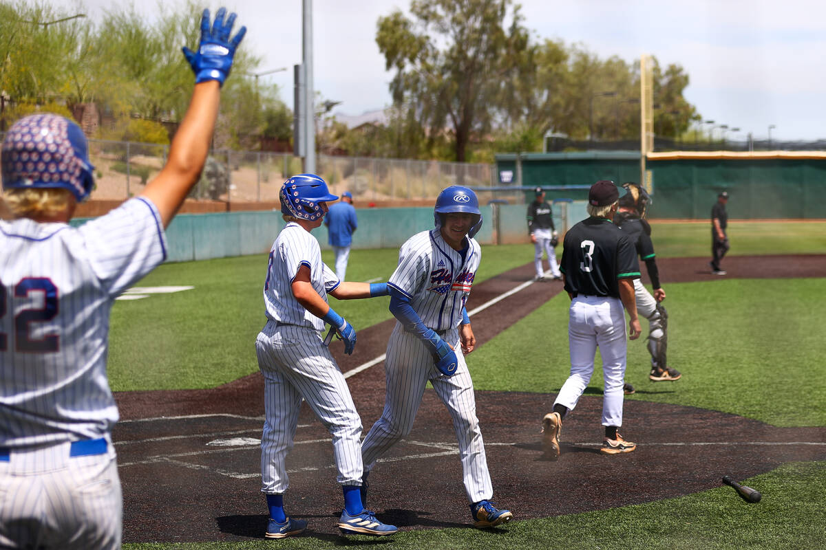 Reno’s Jackson Berg (14) scores at home plate during a Class 5A baseball state title gam ...