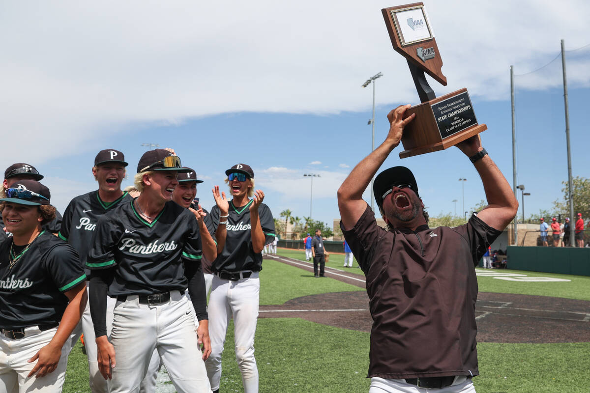 Palo Verde head coach Dustin Romero cheers with his team’s championship trophy after the ...
