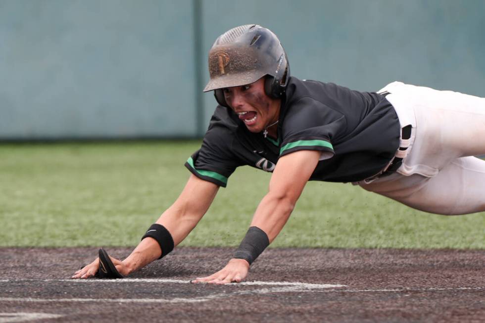 Palo Verde infielder Luke Herrera (2) dives to score at home plate during a Class 5A baseball s ...