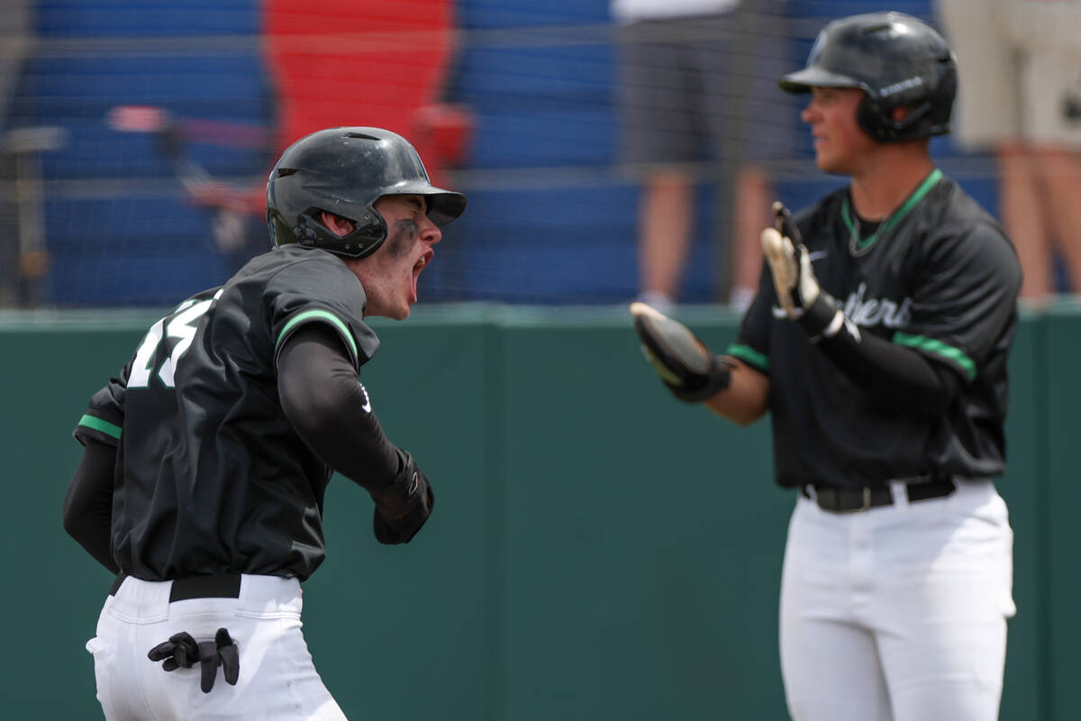 Palo Verde infielder Andrew Kaplan (15) celebrates after scoring while infielder Tanner Johns ( ...