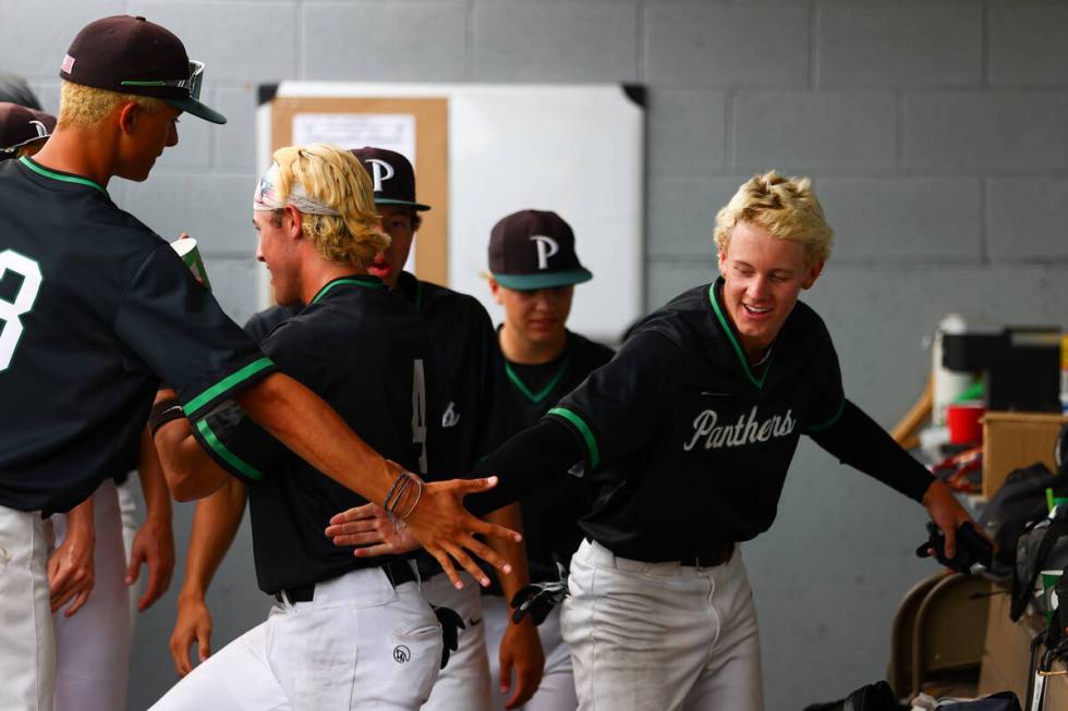 Palo Verde infielder Ethan Clauss, right, is congratulated after scoring during a Class 5A base ...