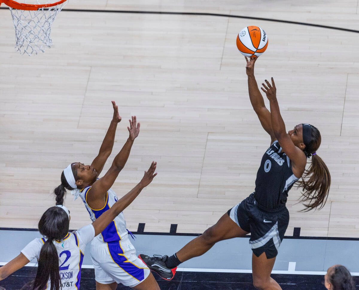 Aces guard Jackie Young (0) gets off a shot over Los Angeles Sparks guard Aari McDonald (15) du ...