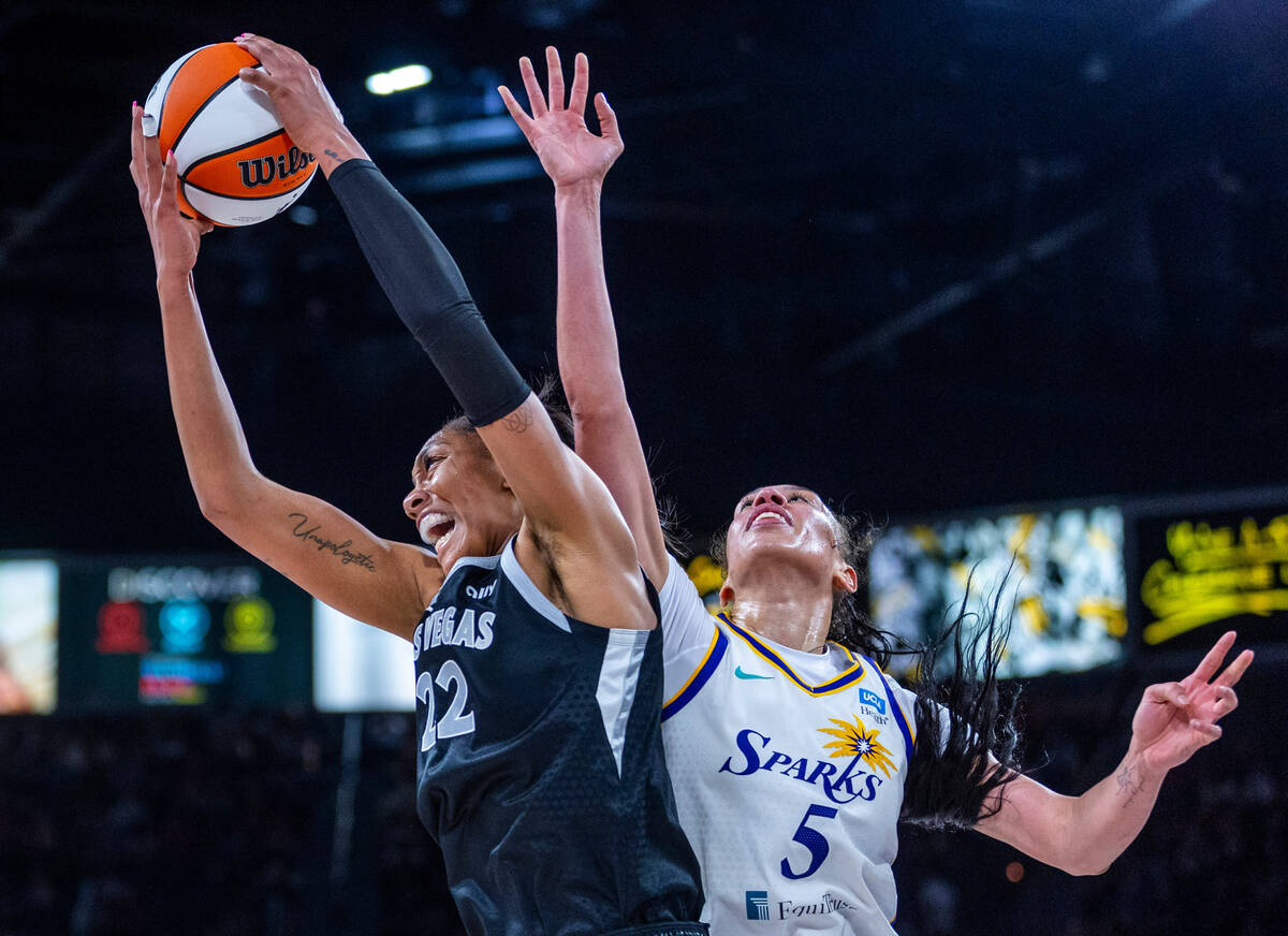 Aces center A'ja Wilson (22) battles underneath the basket for a rebound beating Los Angeles Sp ...