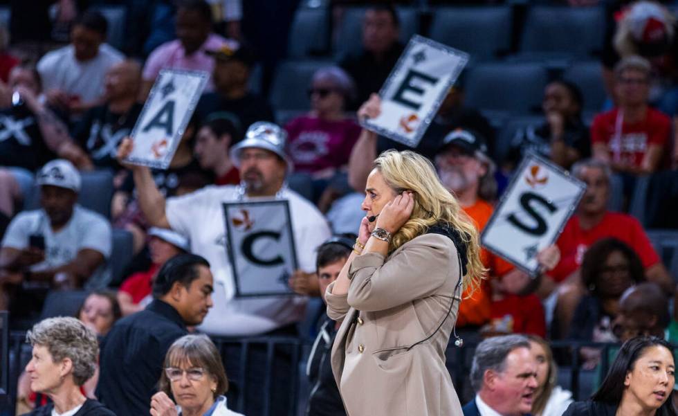 Aces head coach Becky Hammon listens to a headset on a break in the action against the Los Ange ...