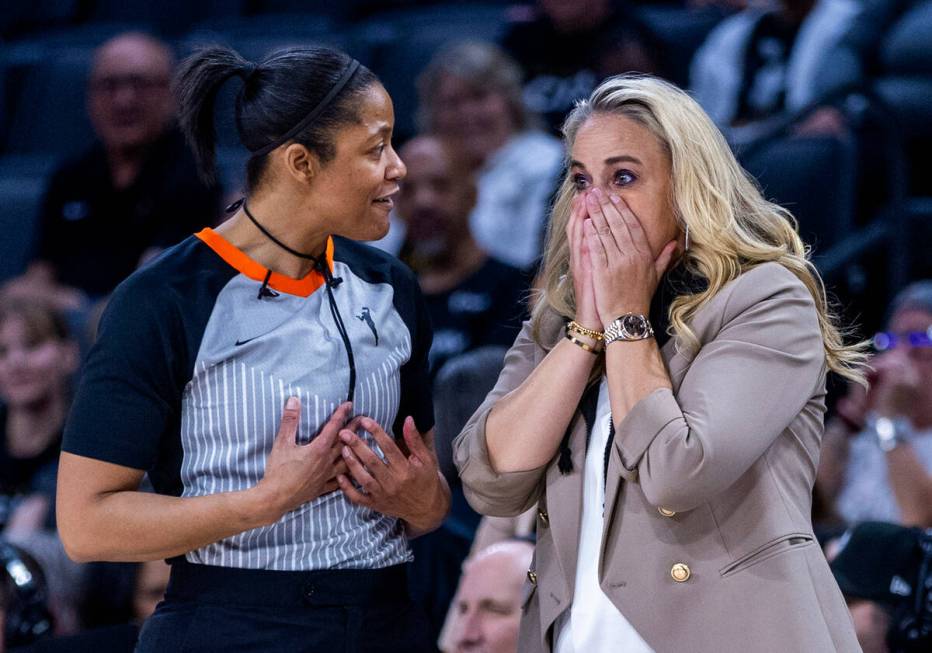 Aces head coach Becky Hammon is shocked by a call as an official attempts to explain herb side ...