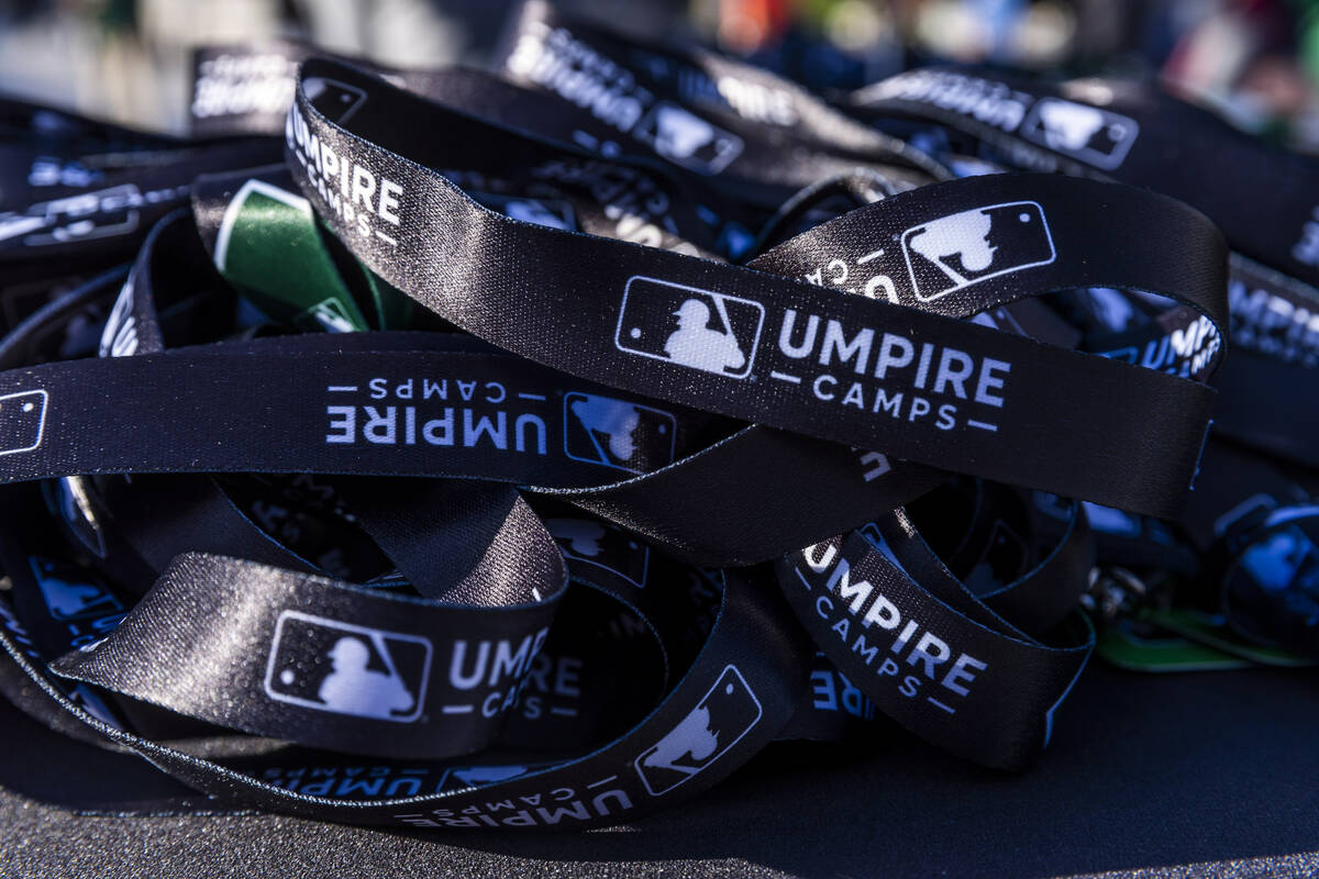 Credential await participants as they line up to enter the Las Vegas Ballpark for a Major Leagu ...