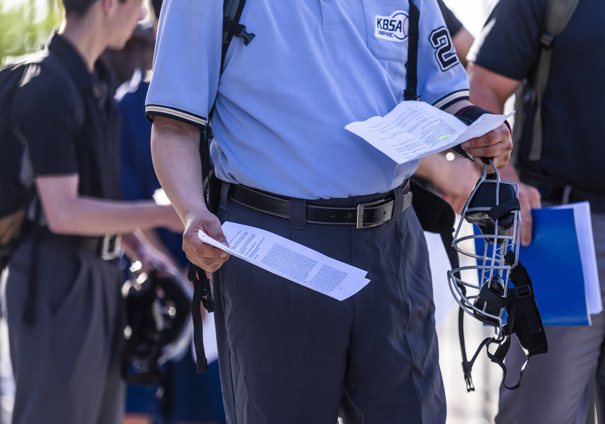 Participants have their paperwork ready as they line up to enter the Las Vegas Ballpark for a M ...