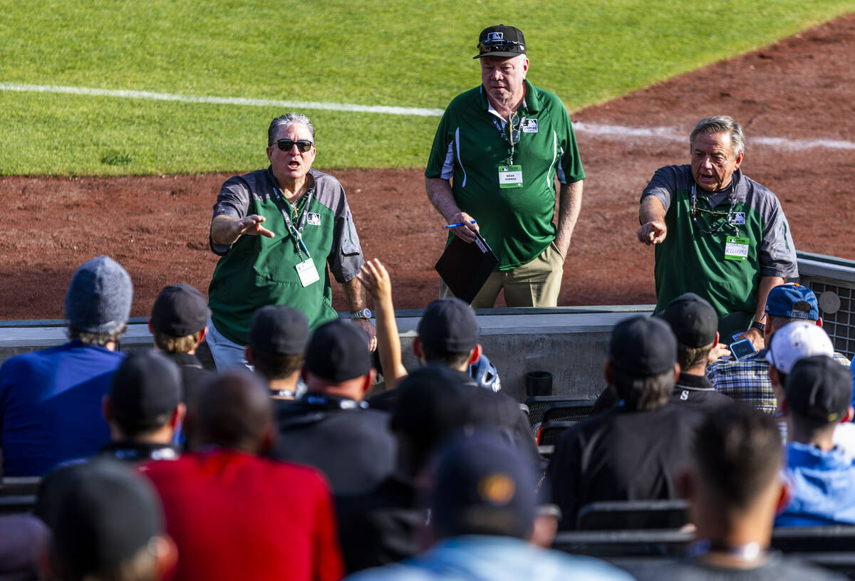 Staffers answer questions for participants during a Major League camp for umpires at the Las Ve ...