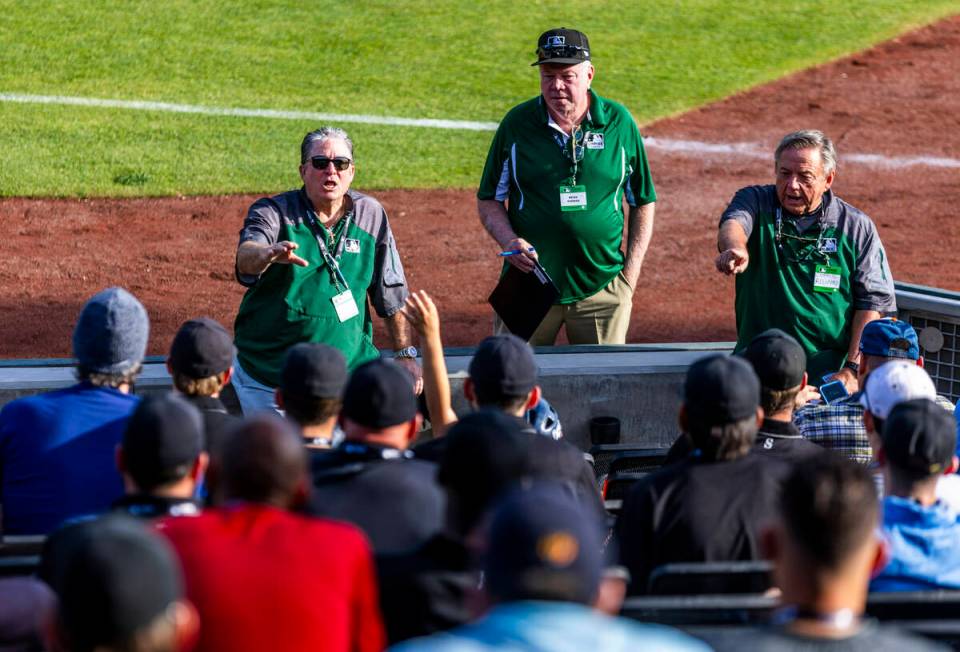 Staffers answer questions for participants during a Major League camp for umpires at the Las Ve ...