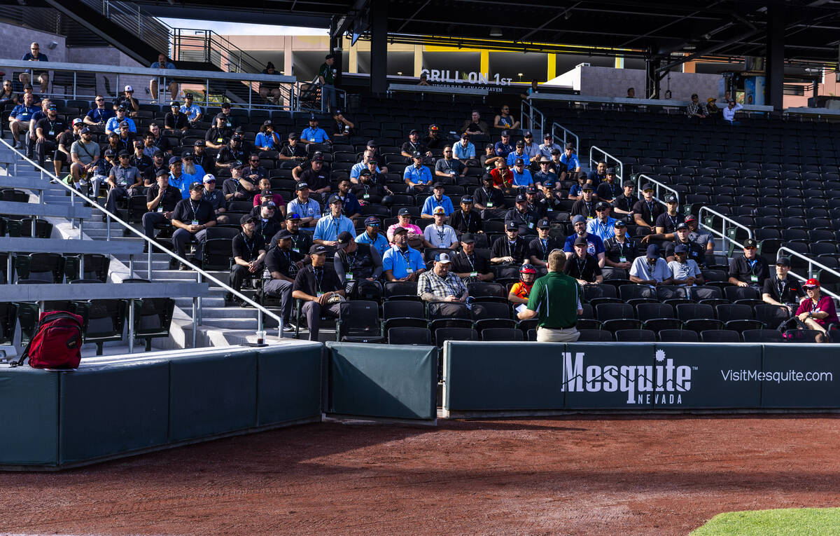 A staffer answers questions for participants during a Major League camp for umpires at the Las ...