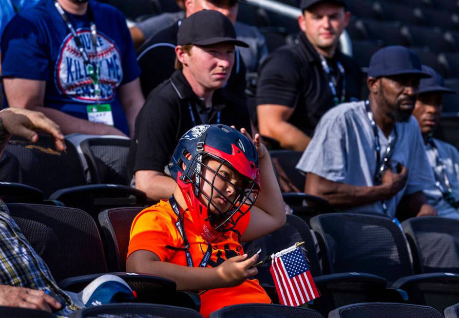 Participants, even young ones, listen to staff instructions during a Major League camp for umpi ...