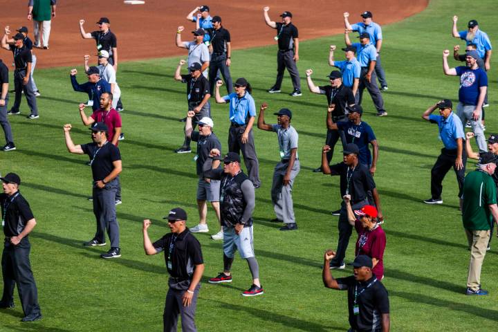 Participants practice their "out" calls for staff during a Major League camp for umpi ...