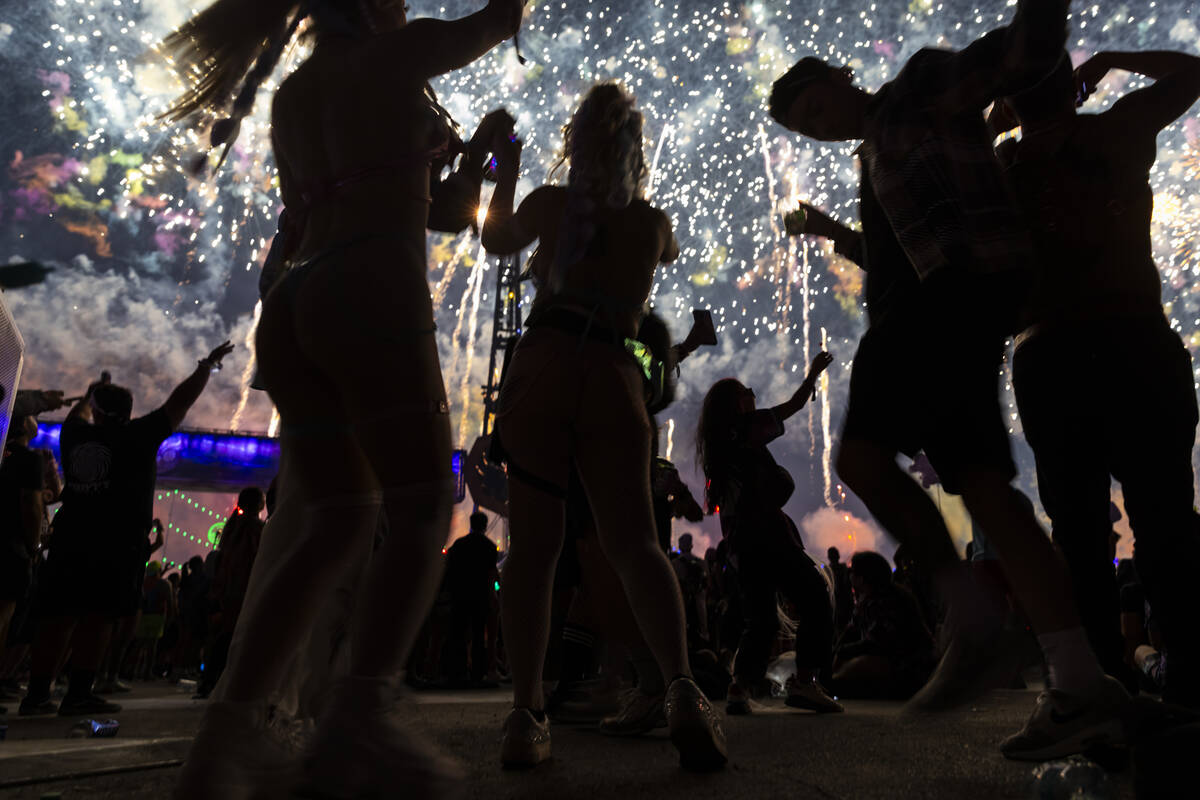 Festival attendees dance as fireworks go off during the third night of the Electric Daisy Carni ...