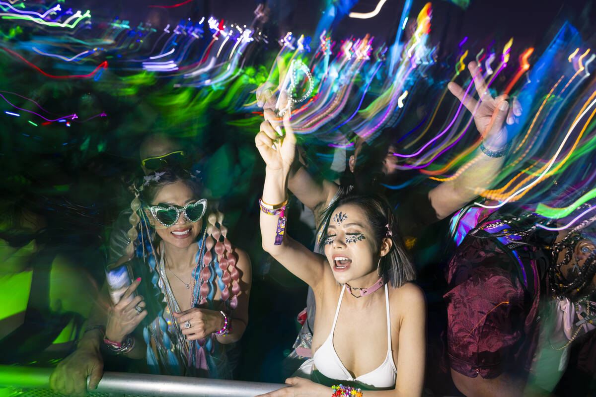 Festival attendees dance as Kaskade performs at Kinetic Field during the third night of the Ele ...