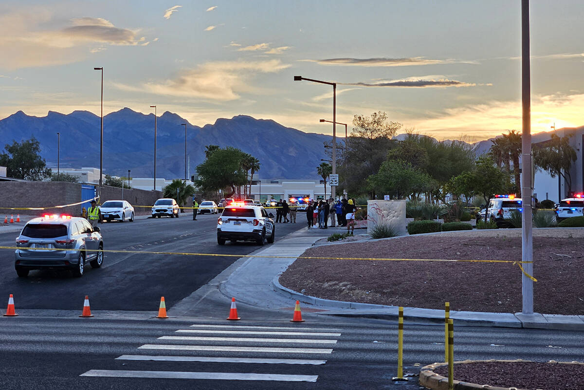 Metro police remain at the scene of a triple shooting in the 7300 block of Prairie Falcon Road ...