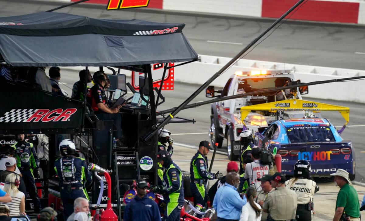 The car of Ricky Stenhouse Jr. is towed away from the pit of Kyle Busch during the NASCAR All-S ...
