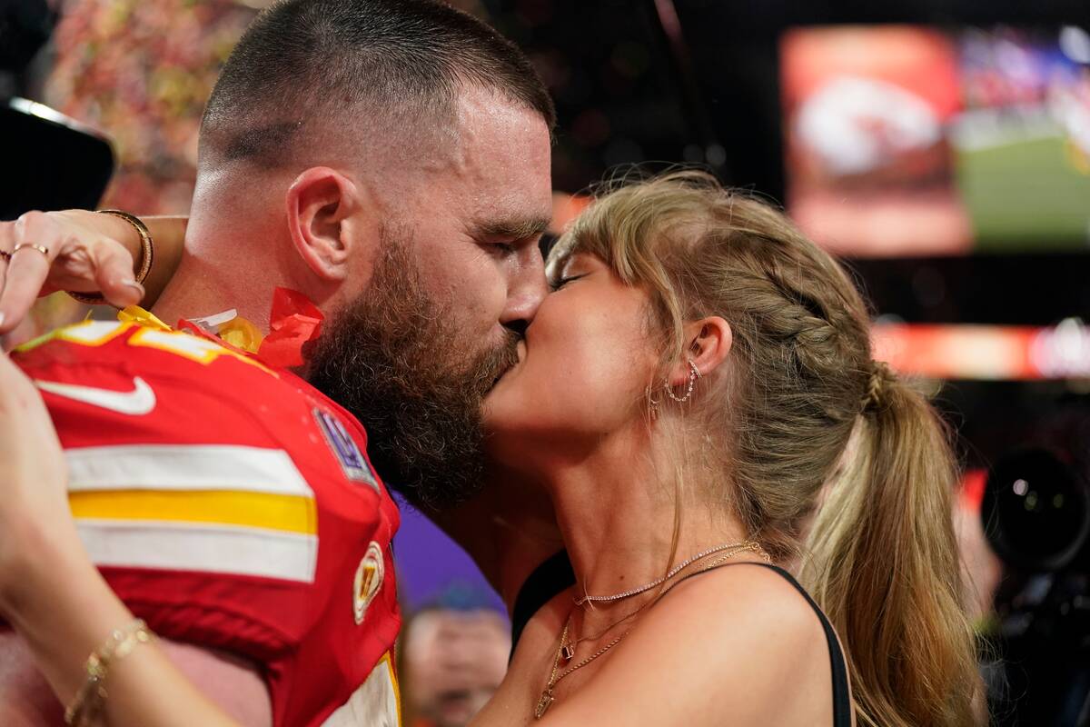 Taylor Swift kisses Kansas City Chiefs tight end Travis Kelce after the NFL Super Bowl 58 footb ...