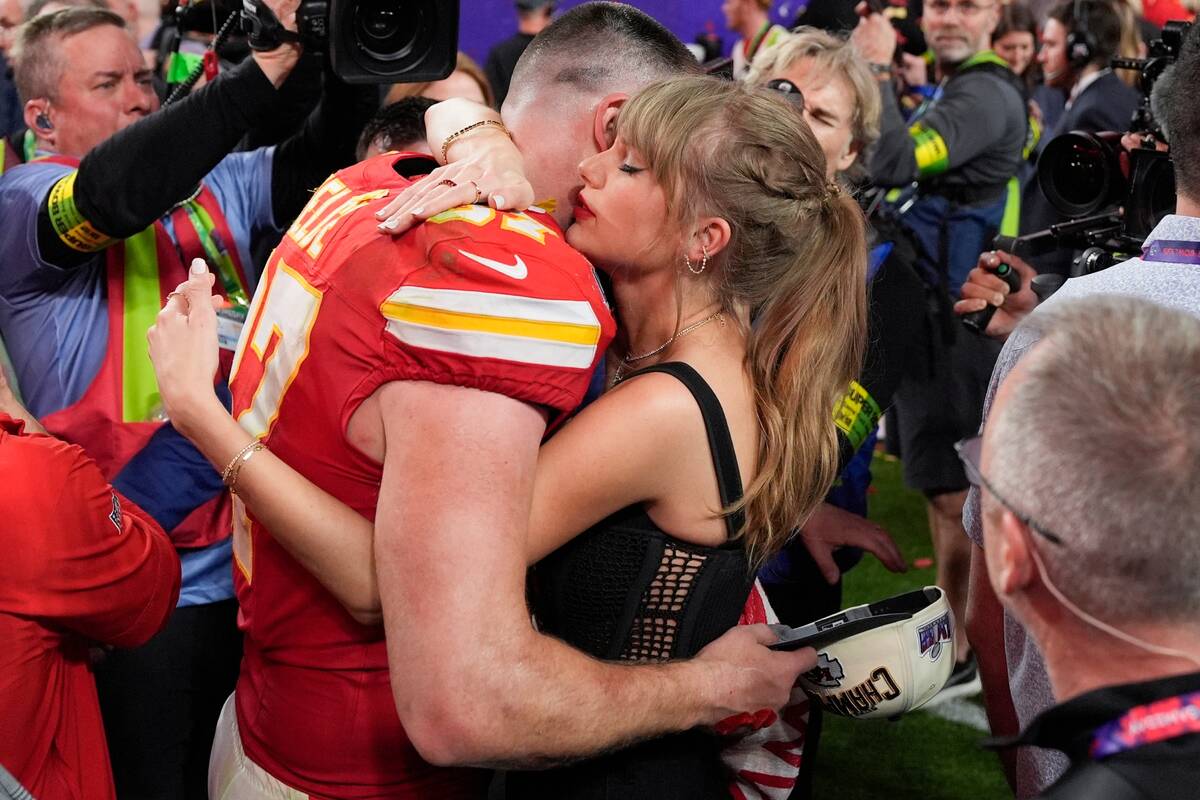Taylor Swift embraces Kansas City Chiefs tight end Travis Kelce after the NFL Super Bowl 58 foo ...