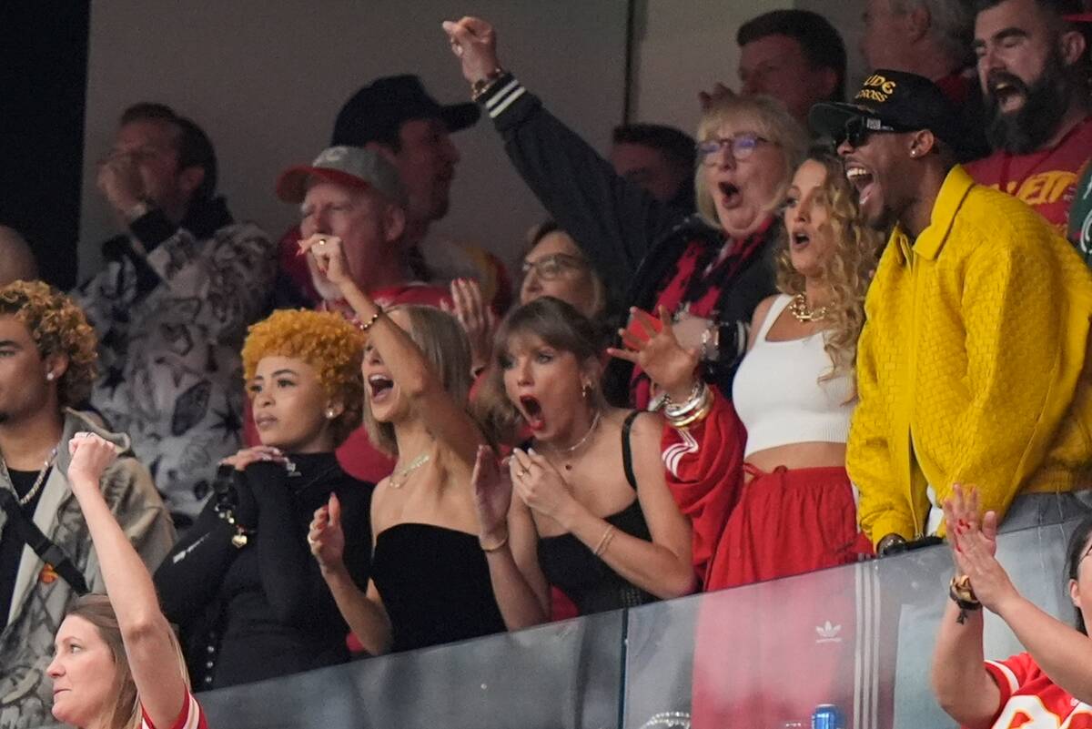 Taylor Swift, center, reacts with Ice Spice, from left, Ashley Avignone and Blake Lively to a p ...
