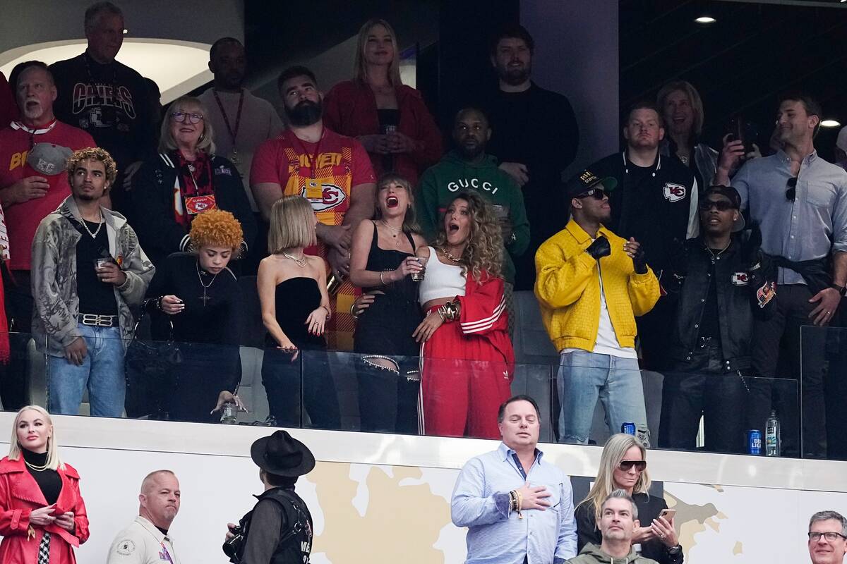 Taylor Swift, center left, and Blake Lively watch before the NFL Super Bowl 58 football game be ...