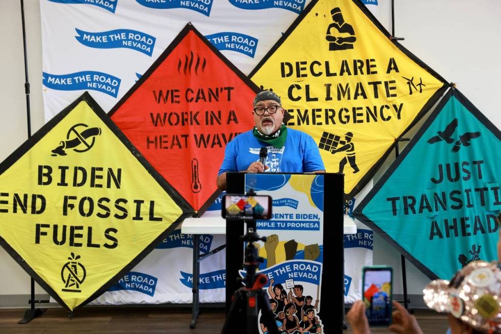 Gerardo Velasquez, a construction worker who installs solar panels, speaks with activists from ...