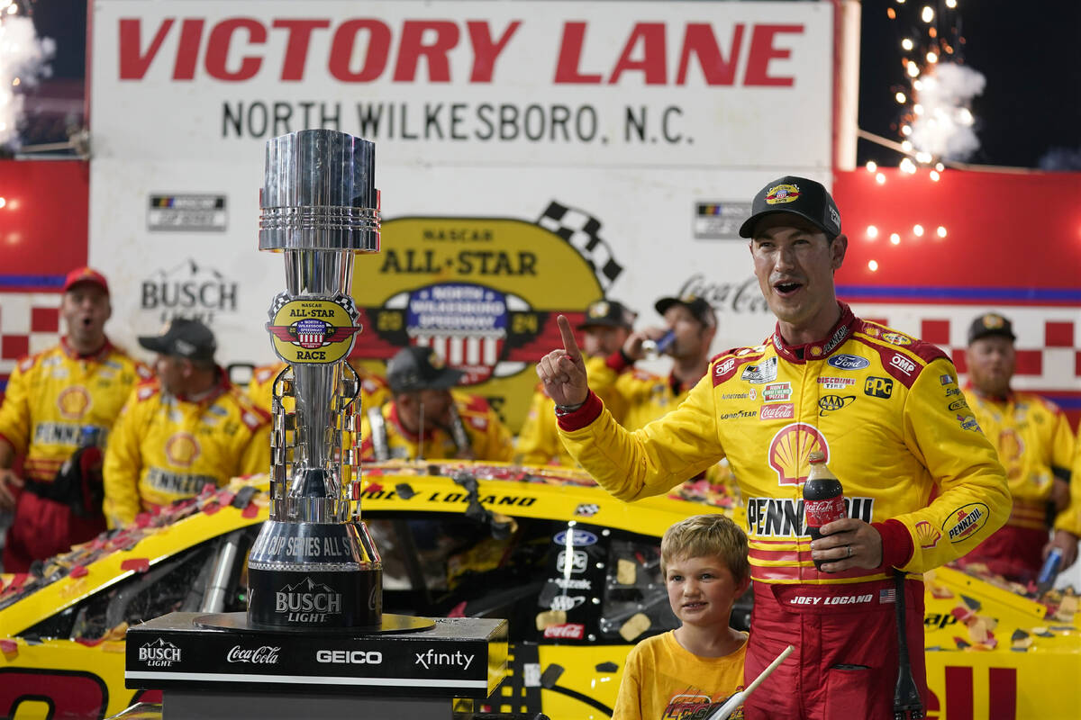Joey Logano poses with the trophy in Victory Lane after winning the NASCAR All-Star auto race a ...