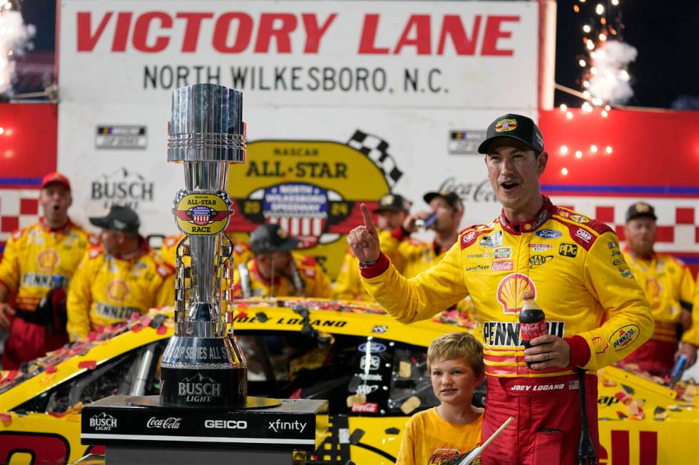 Joey Logano poses with the trophy in Victory Lane after winning the NASCAR All-Star auto race a ...