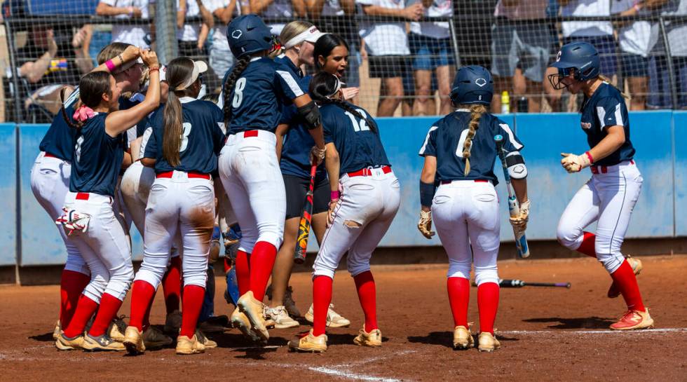 Coronado players celebrate a home run by Bailey Goldberg (1) against Douglas during the fourth ...