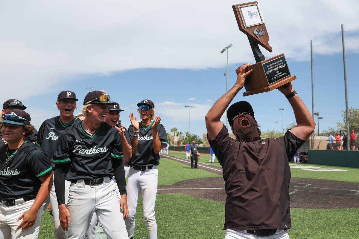 Palo Verde head coach Dustin Romero cheers with his team’s championship trophy after the ...
