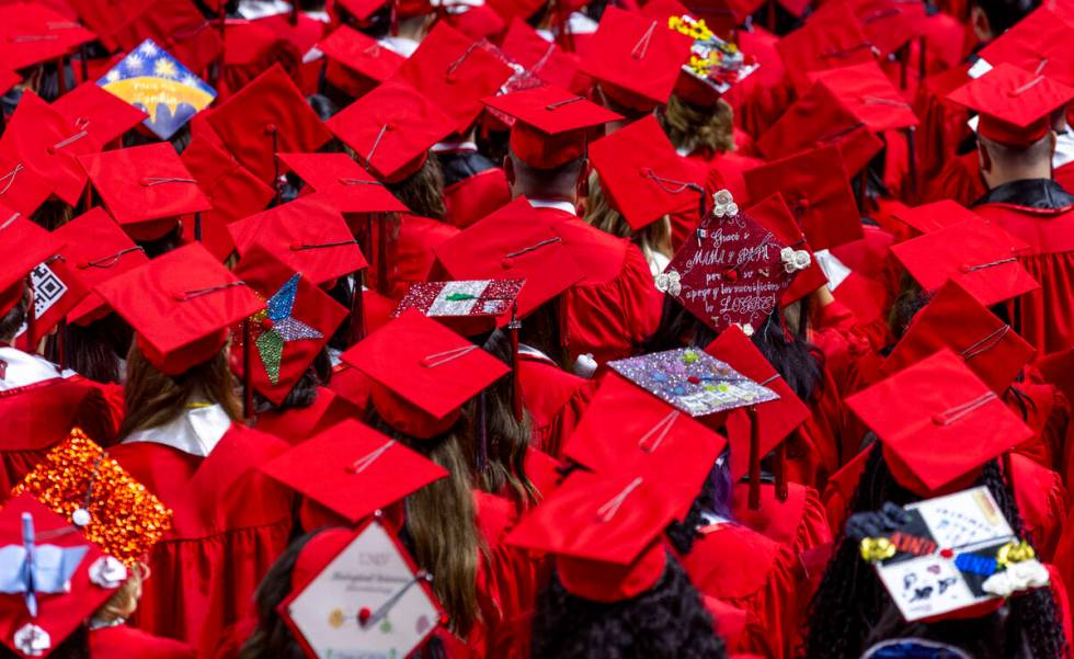 Some graduates wear custom mortar boards during UNLV spring graduation commencement exercises a ...