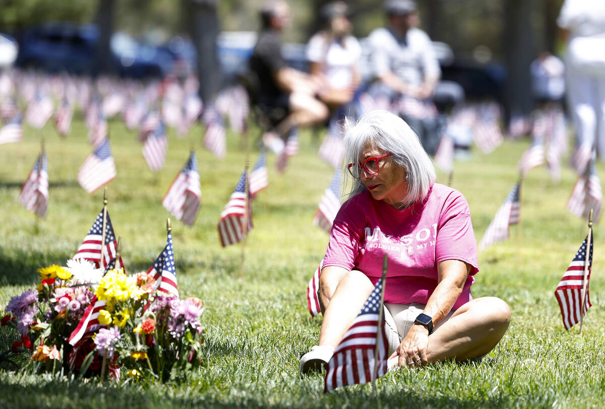 Marina Vance of Henderson visits the grave of her son Army Spc. Ignacio Ramirez, who died fight ...