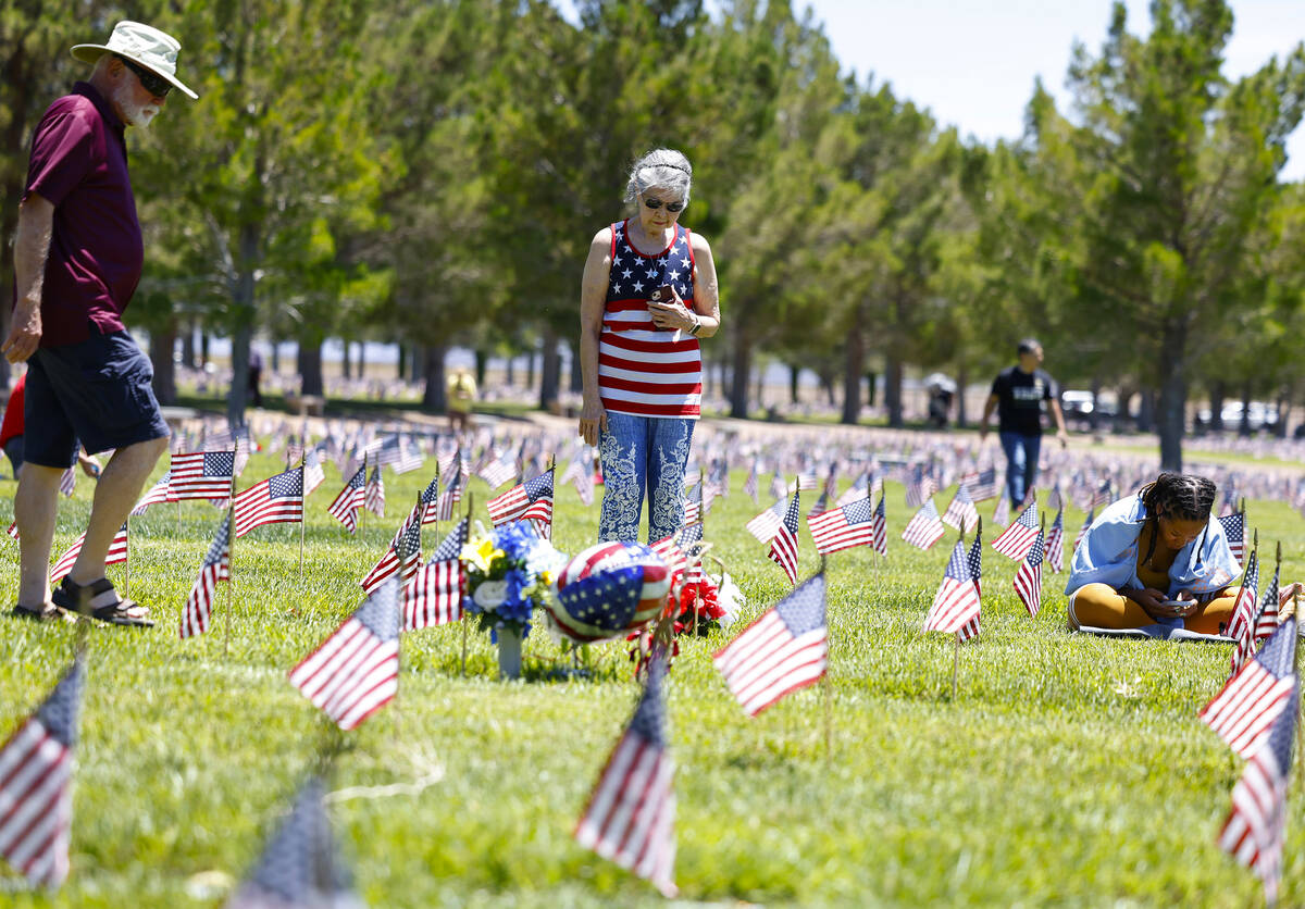 Nellie Salvador of Henderson, center, visits the grave of her husband U.S Navy Senior First Cla ...