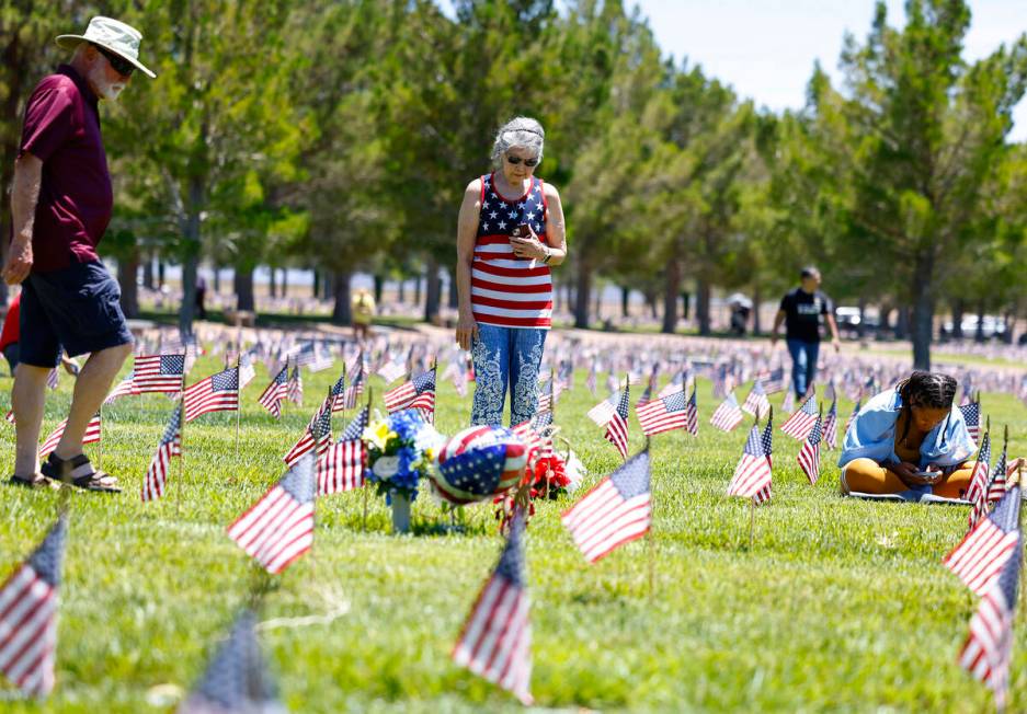 Nellie Salvador of Henderson, center, visits the grave of her husband U.S Navy Senior First Cla ...