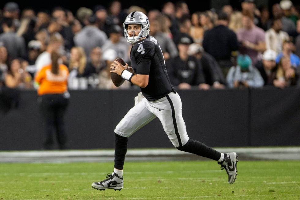 Raiders quarterback Aidan O'Connell (4) scrambles out of the pocket during the second half of a ...