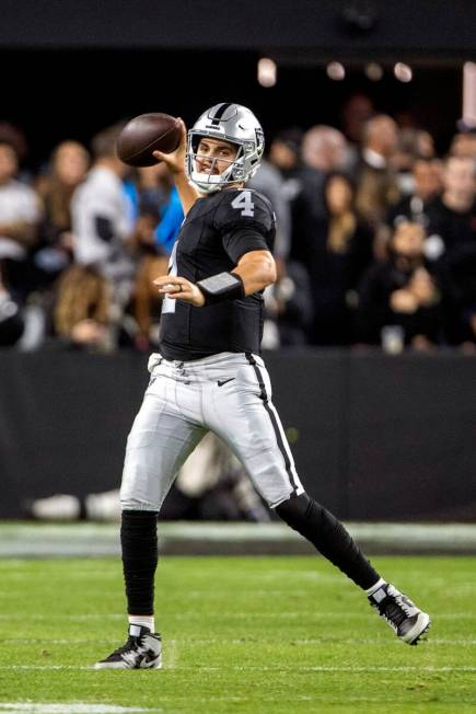 Raiders quarterback Aidan O'Connell (4) makes a throw during the second half of an NFL game aga ...