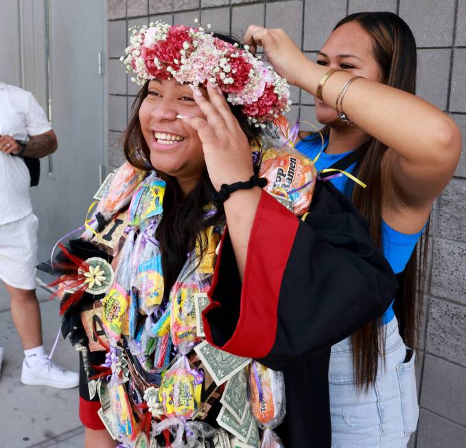 Adult Education graduate Tianna Seloti gets a lei from cousin Dallynn Manutai after her graduat ...