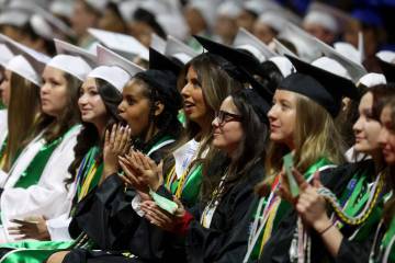 Green Valley High School students applaud a speaker during graduation at Thomas & Mack Center o ...