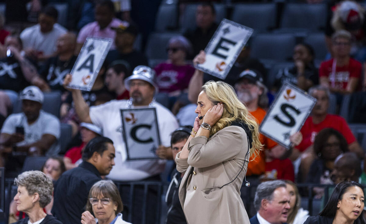 Aces head coach Becky Hammon listens to a headset on a break in the action against the Los Ange ...