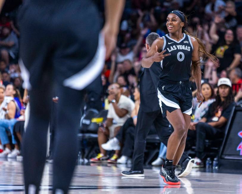 Aces guard Jackie Young (0) signals another three-point basket over the Los Angeles Sparks duri ...